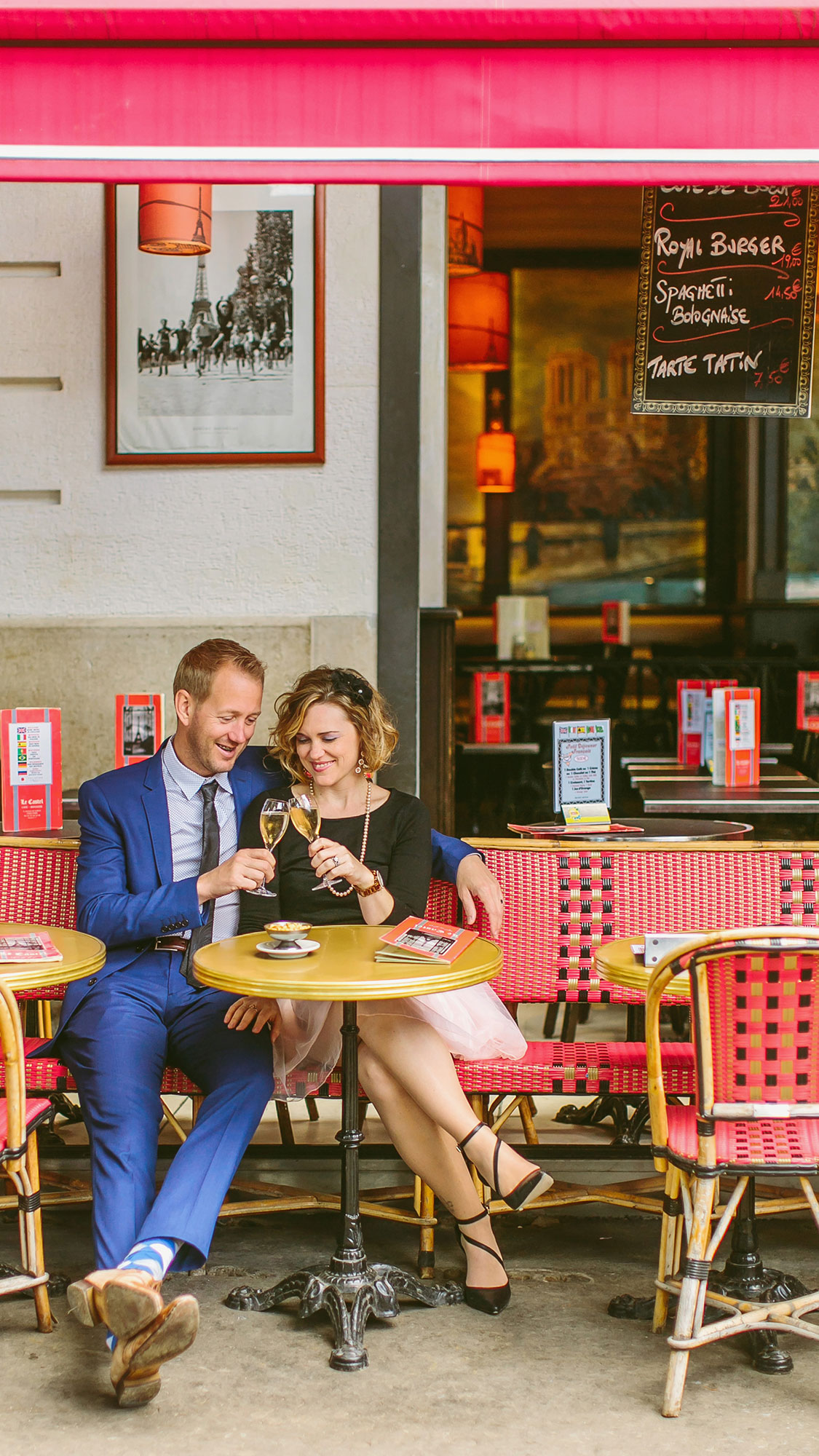 best paris elopement photographers cheyanne and doug toasting at a cafe