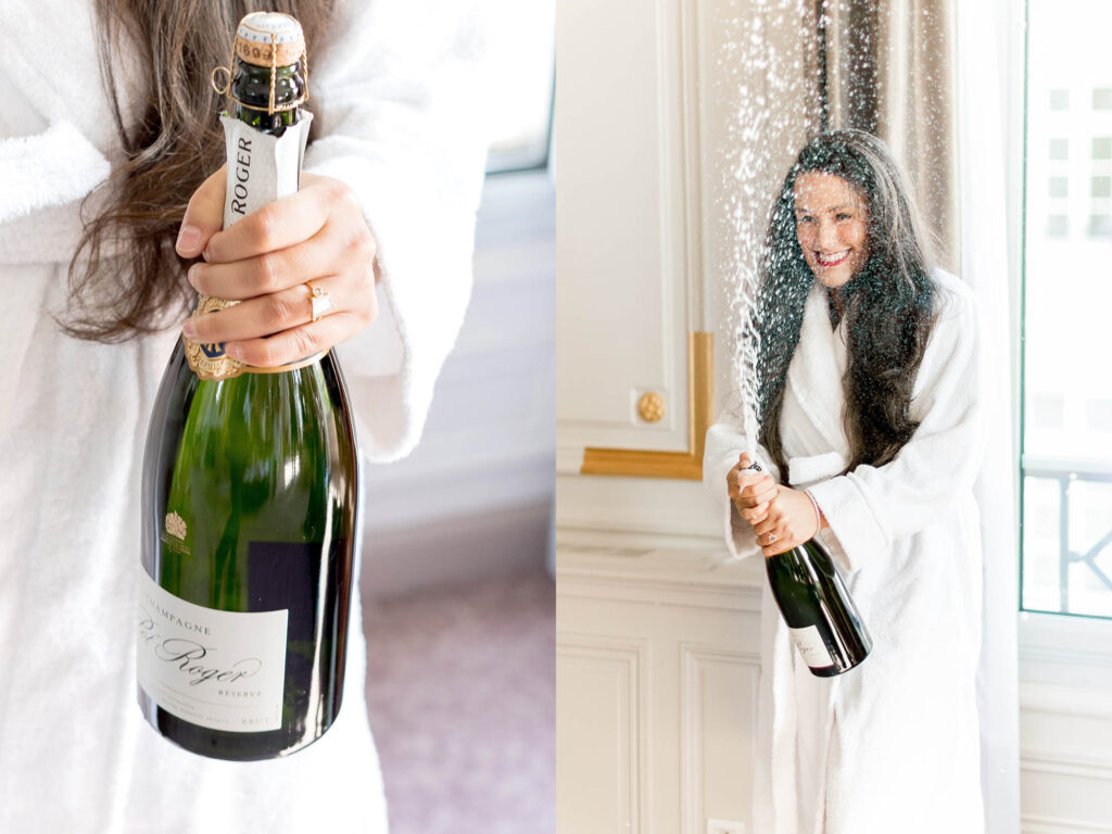a bride poppping a bottle of champagne on her wedding day