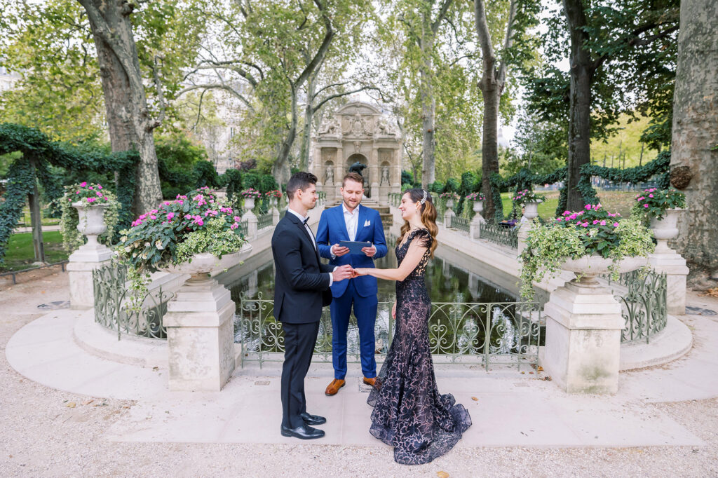 a couple eloping in Paris in front of the Medici Fountain in Luxembourg Gardens
