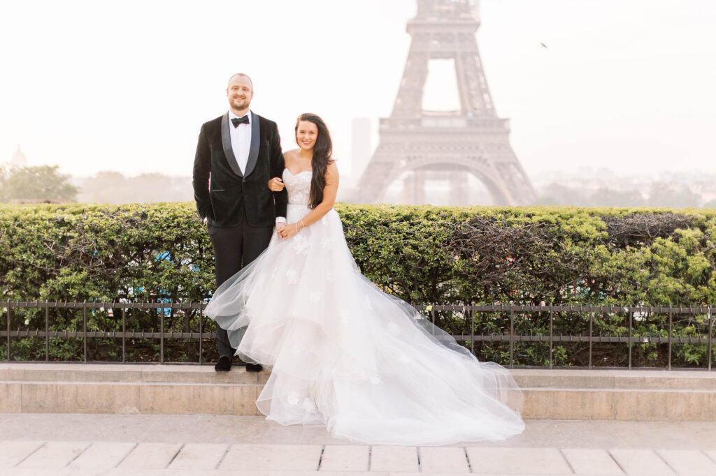 couple posing for a romantic portrait in front of the Eiffel Tower in Paris